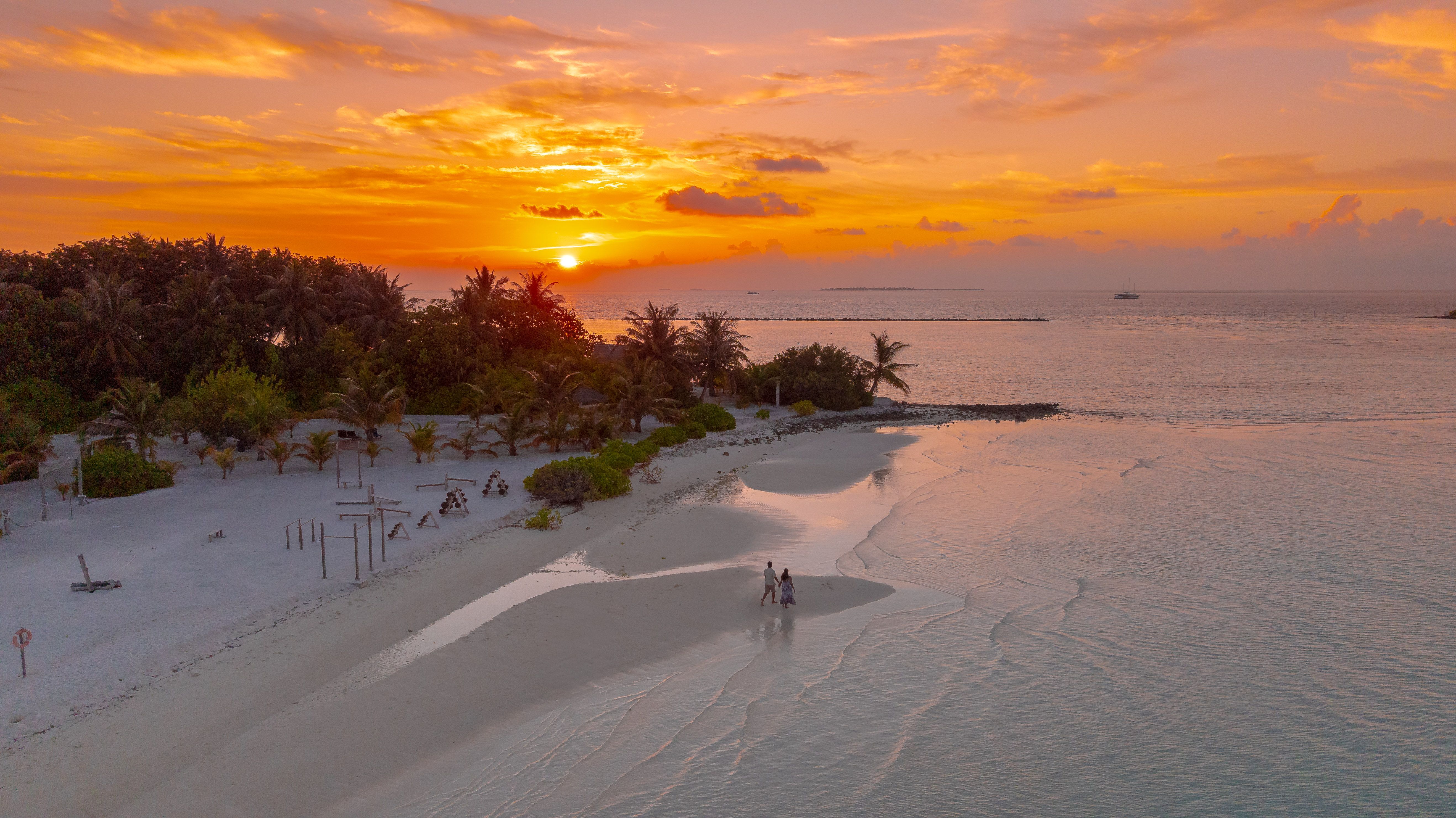 Maldives resort at sunset showing ideal weather conditions