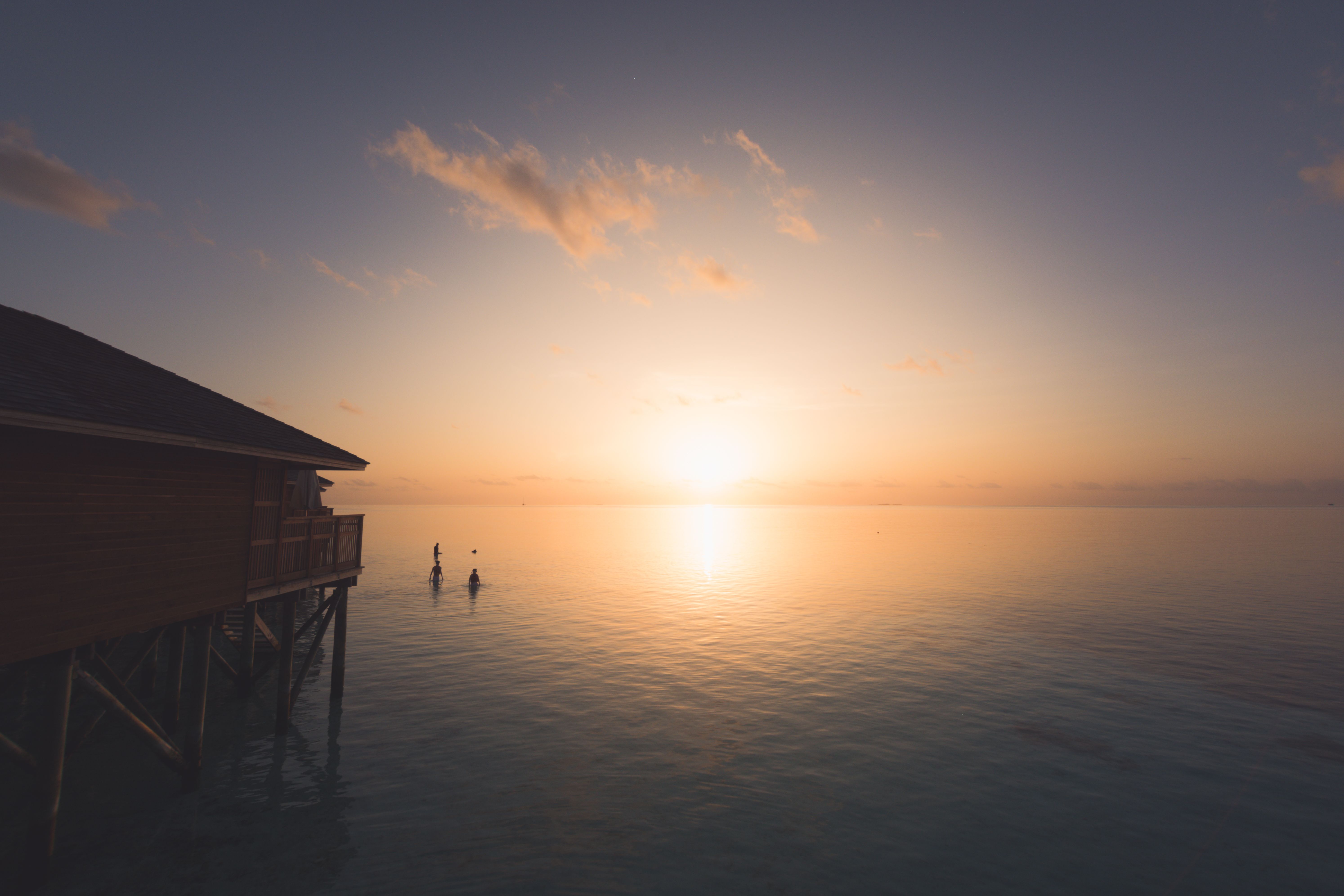 Maldives overwater villa at sunset, honeymoon setting